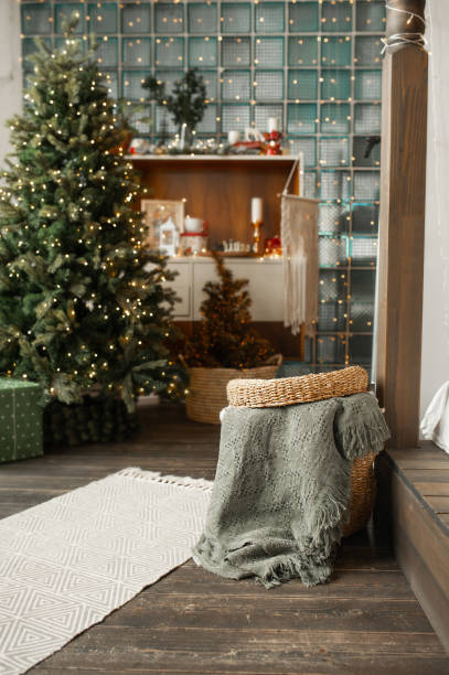 istock grey Christmas interior natural eco-components. Wicker straw basket for storing clothes on background of boho-style bedroom with wicker baskets and wooden shelves. vertical content, selective focus 1355044305