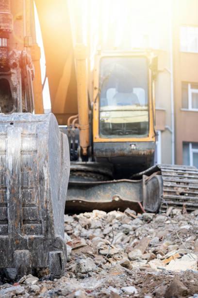 istock Hydraulic crusher excavator backoe machinery working on site demolition 1355046054