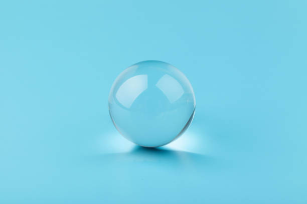 istock Crystal glass ball sphere transparent on blue background. 1355046083