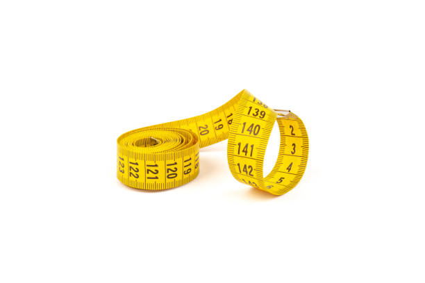 istock Yellow measuring tape spiral, isolated on white background. 1355046106