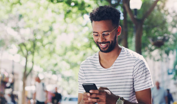 istock Shot of a young man using his smartphone to send a text message 1355046272