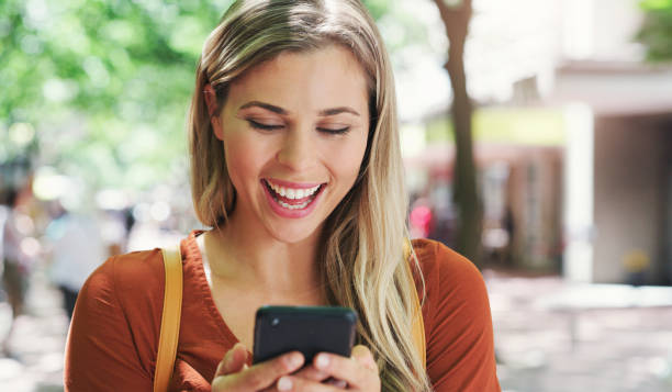 istock Shot of a young woman using her smartphone while walking outside 1355046318