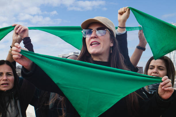 Green wave abortion Hispanic women with green scarves on reproductive rights and safe end pegnancy protest in Latin America reproductive rights stock pictures, royalty-free photos & images