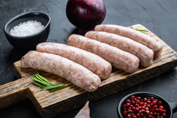 istock Raw chicken sausages, on black background 1355047581
