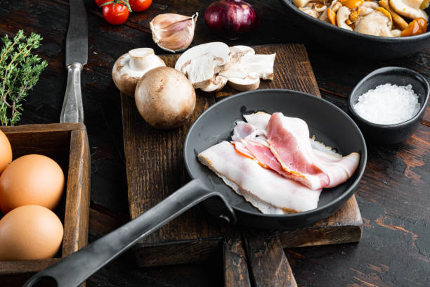 Breakfast egg ingredients, on old dark  wooden table background