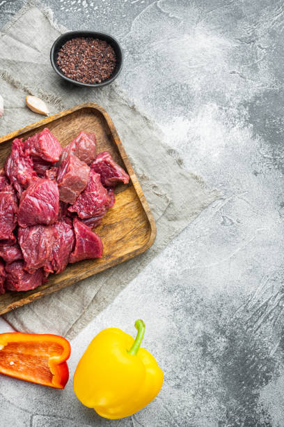 istock Beef stew prepared  for goulash cooking, on gray stone background, top view flat lay, with copy space for text 1355047793