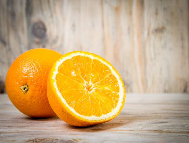 istock Fruit. Orange on a wooden background 1355047859