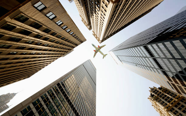 istock Airplane flying over skyscrapers, NYC. 1355049104
