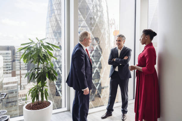 Financial advisors standing and talking in modern office