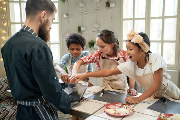 istock Children helping the chef to cook 1355052631