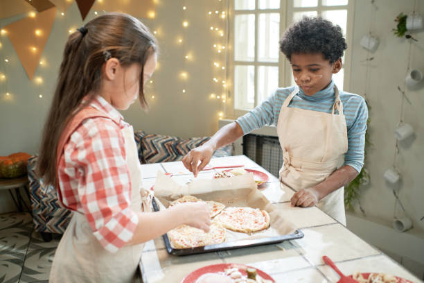 istock Children making homemade pizza 1355052722