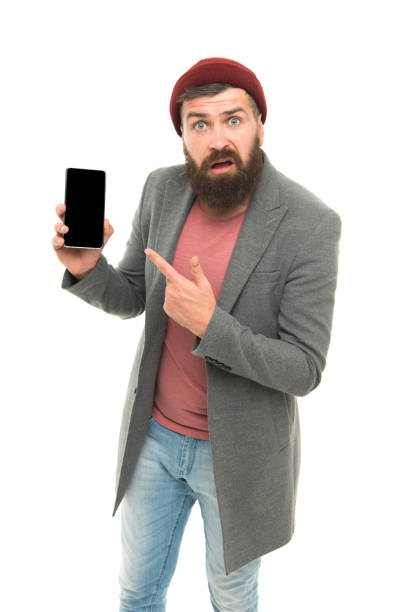 istock Smart communication at your fingertips. Modern bearded man pointing finger at mobile communication device. Hipster using communication technology. The next level of communication 1355052766