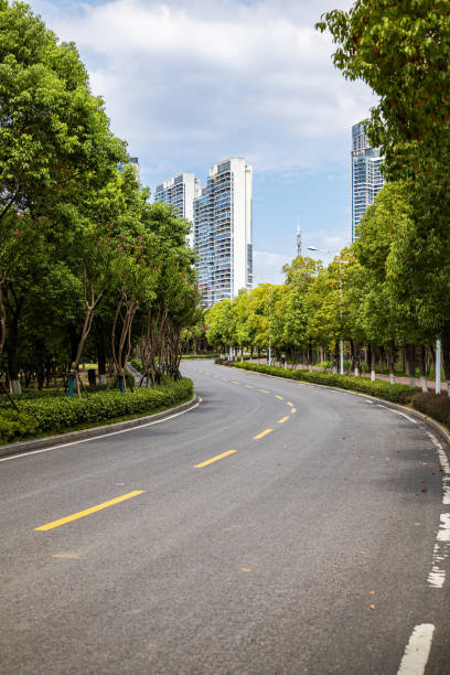 istock City road through modern buildings 1355052844
