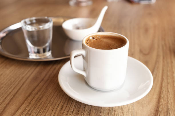 istock Traditional Turkish coffee with cold water and Turkish delight in cafe. Selective focus 1355053147