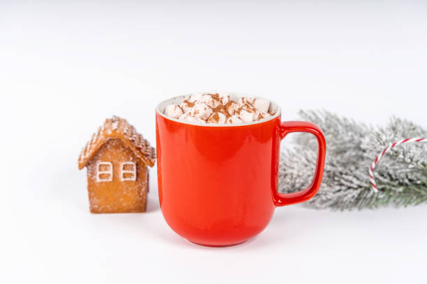 istock Christmas cocoa mug with marshmallow on a white background with gingerbread. Copy space banner 1355054084