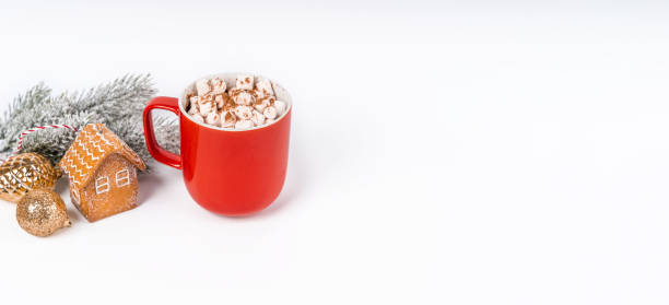 istock Christmas cocoa mug with marshmallow on a white background with gingerbread. Copy space banner 1355054110