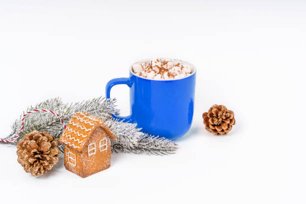 istock Christmas cocoa mug with marshmallow on a white background with gingerbread. Copy space banner 1355054151