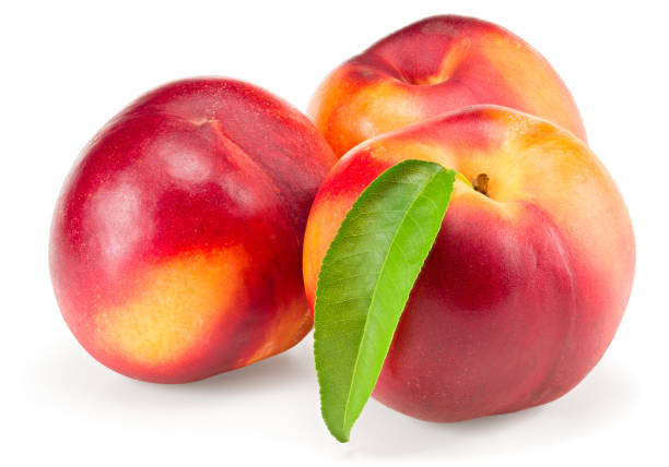 istock Nectarine with green leaf isolated on white background. clipping path 1355054359