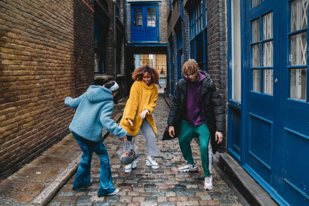 istock Three happy friends dancing together in the city 1355054548