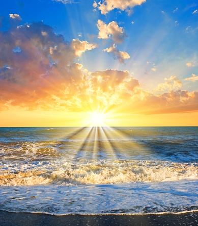 sun sitting into a sea