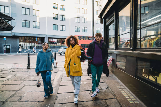 istock Hip friends walking in the city 1355054571