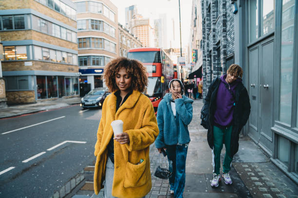 istock Hip friends walking in the city 1355054576