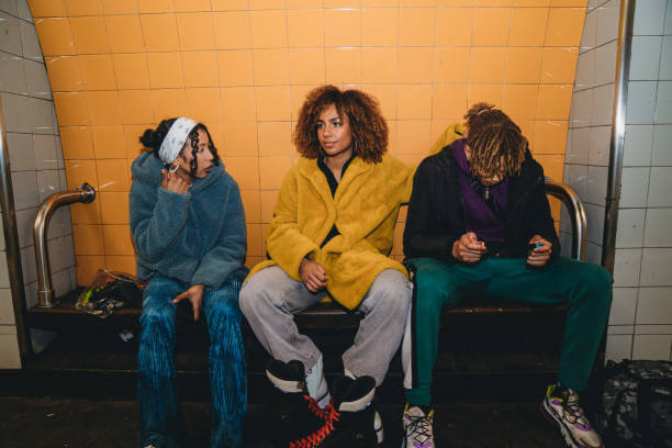 istock Three friends waiting for the train in a subway station 1355054583