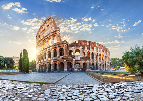 The Colosseum in the morning sun rays, beautiful morning view of Rome, Italy.