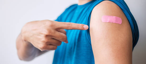 istock man showing bandage after receiving covid 19 vaccine. Vaccination, herd immunity, side effect, booster dose, vaccine passport and Coronavirus pandemic 1355059921