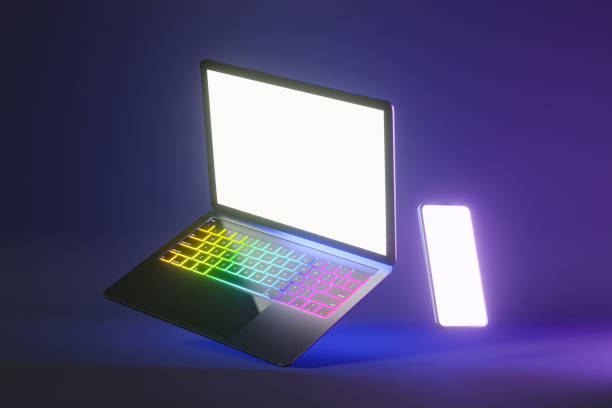 istock 3D illustration rendering object. Laptop computer silver and black color with smartphone mobile blank screen in blue pink light color background. 1355060038