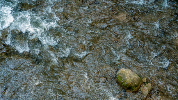 istock Close up Beautiful waterfall on the mountain with blue sky shining sun. Waterfall in the mountains of the North Caucasus. Nature abstract background. 1355060355