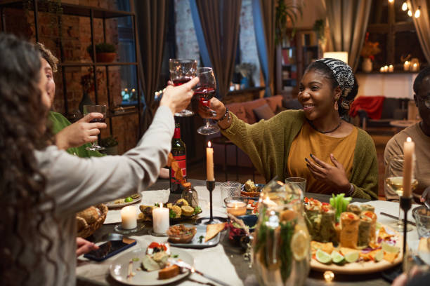 istock Friends toasting with red wine at the table 1355060764
