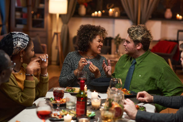 istock Friends having fun at dinner party 1355060791