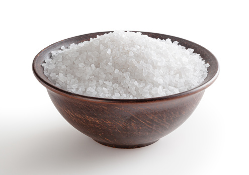 Sea salt in ceramic bowl isolated on white background with clipping path