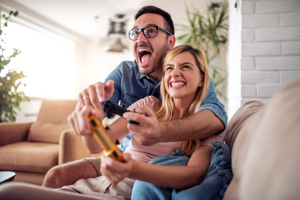 istock Young couple playing video games 1355061848