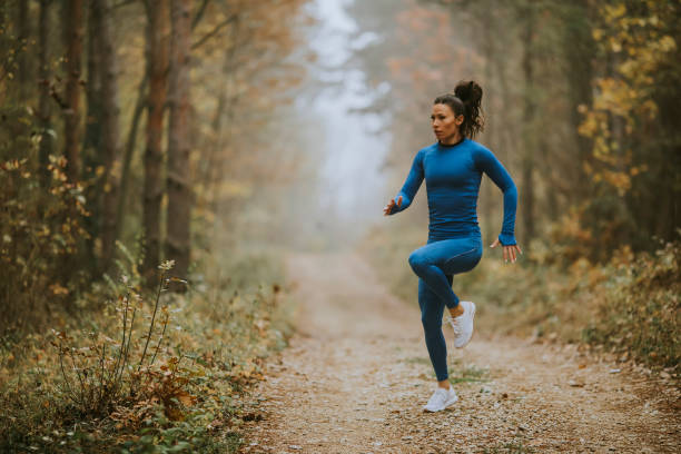 istock Young woman running having exercise on forest trail at autumn 1355061863