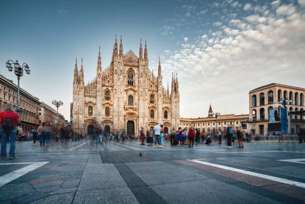 Piazza Duomo in Milan at sunset Piazza Duomo in Milan at sunset. Blurred motion because of the long exposure. Italian international landmark. milan stock pictures, royalty-free photos & images