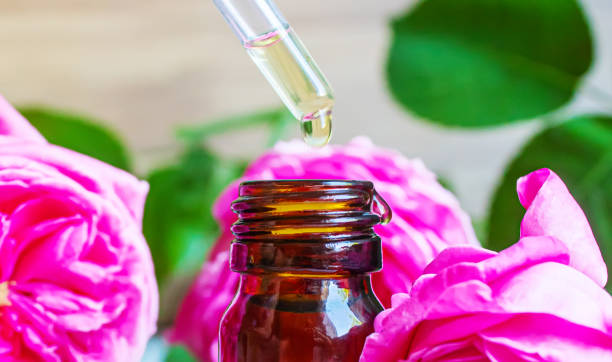 istock tea rose oil in a small bottle. selective focus. 1355063729