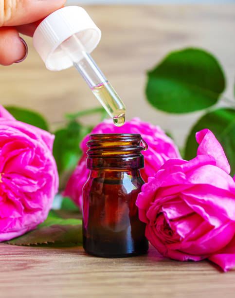 istock tea rose oil in a small bottle. selective focus. 1355063734