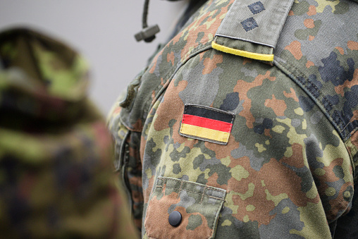 Uniform of the German army with the German flag on the shoulder. German military, selective focus.