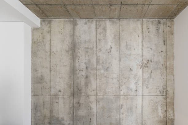 istock Grey concrete wall. Clay wall texture with cracks and imperfections. Modern interior concept. 1355067124