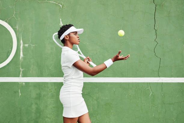 shot of an attractive young woman warming up and getting ready to play tennis outside - womens tennis imagens e fotografias de stock