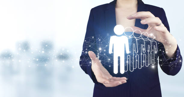 istock Human resources and team management concept. Two hand holding virtual holographic Human, Leader icon with light blurred background. Human search.Leader and CEO. 1355068677