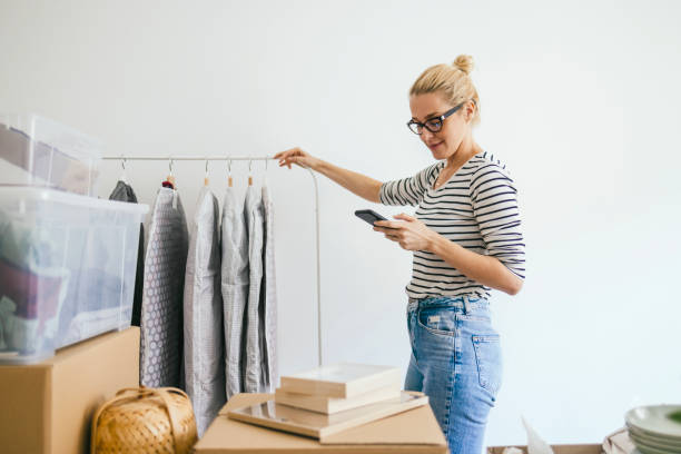 istock Happy Woman Using Mobile Phone in New Home 1355069832