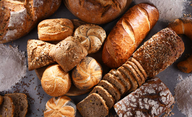 istock Assorted bakery products including loafs of bread and rolls 1355070043