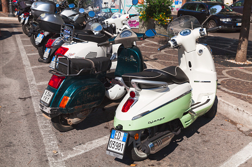 Gaeta, Italy - August 20, 2015: Classic Italian scooters stands parked on a street, back view