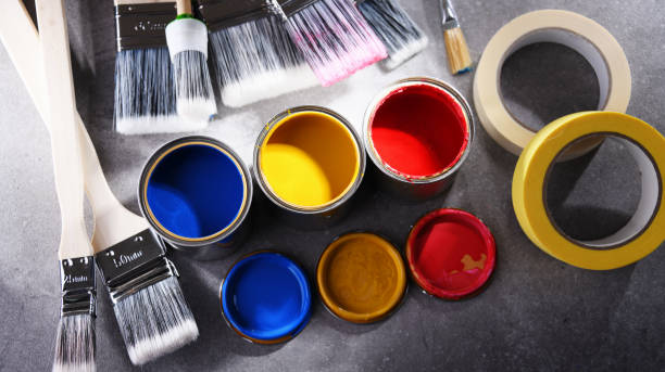 istock Paintbrushes of different size and paint cans 1355070458
