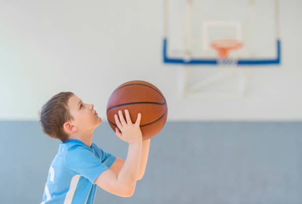 istock Boy Playing Basketball At Court 1355071535
