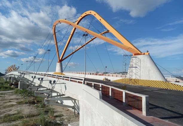 istock Modern Suspension Bridge with Beautiful Orange Arches 1355071648