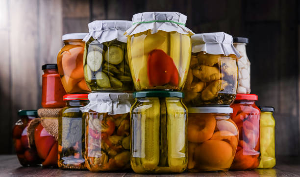 istock Jars with variety of marinated vegetables and fruits 1355073321